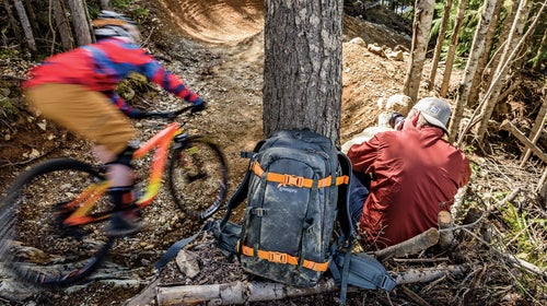 The pack's exterior sheds water like a rain jacket and exterior straps are great for holding tripods, or skis.