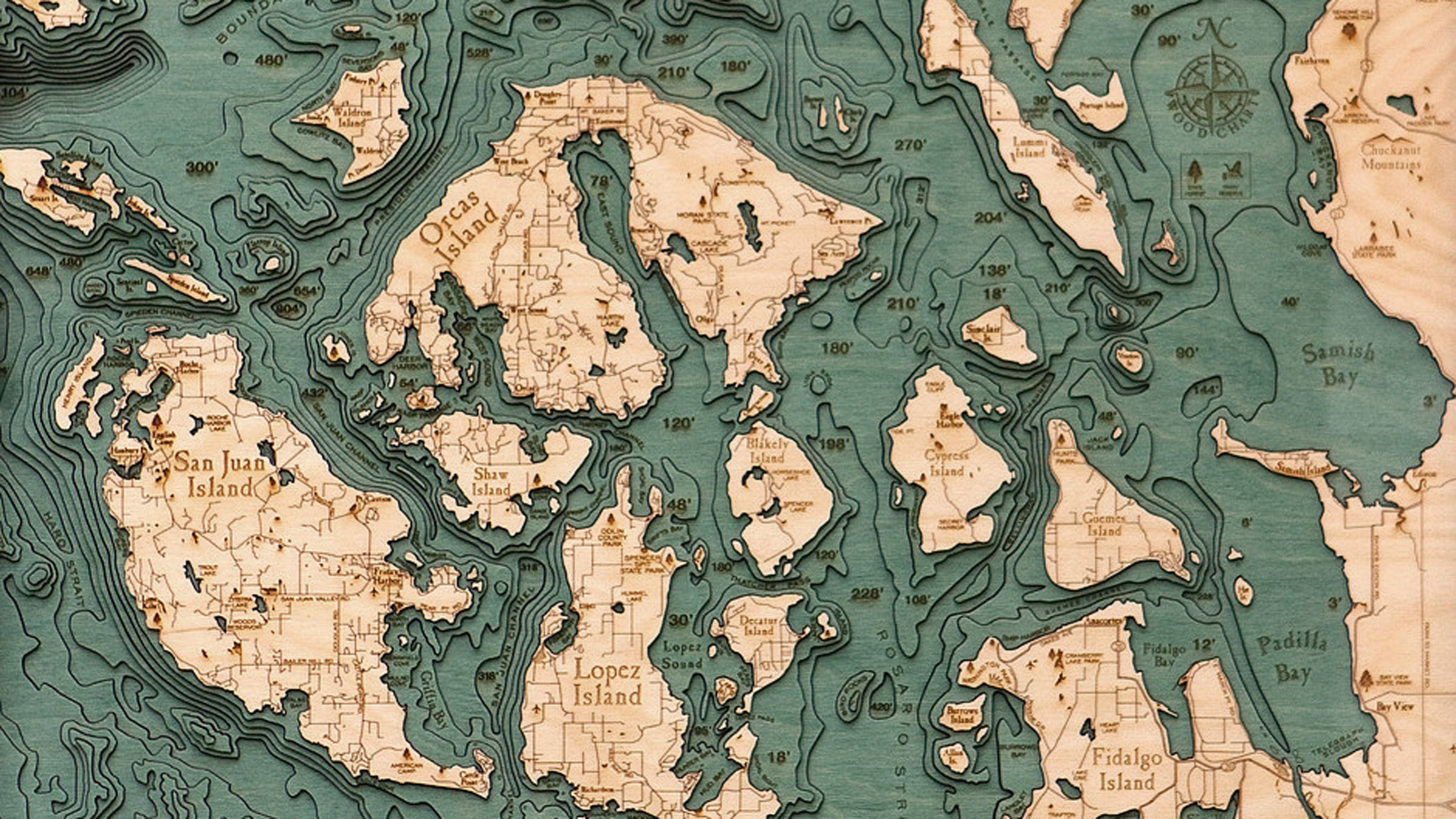 Each map is made with laser-cut layers of wood that are hand-colored.