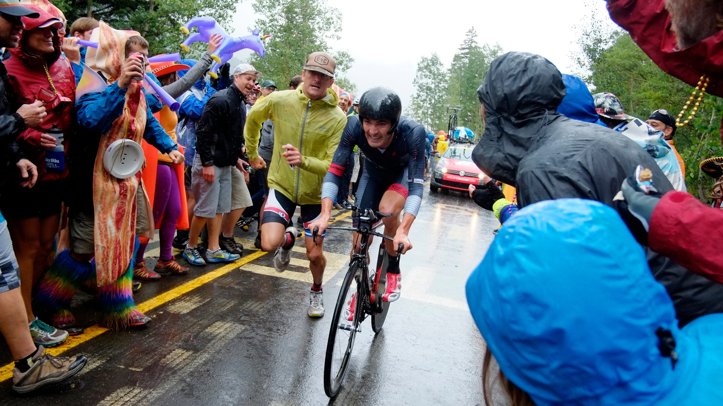 A fan joins USA's Joseph Rosskoph on foot in the last 200 meters of the USA Pro Challenge's Vail Time Trial, August 2014. The event has garnered impressive enthusiasm and crowds.