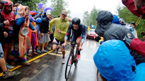 A fan joins USA's Joseph Rosskoph on foot in the last 200 meters of the USA Pro Challenge's Vail Time Trial, August 2014. The event has garnered impressive enthusiasm and crowds.