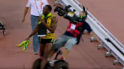 The cameraman's segway caught on another mounted camera's dolly track before he ran into Bolt.