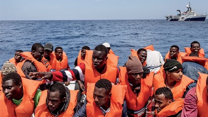 Migrants transfer to rescue boats.