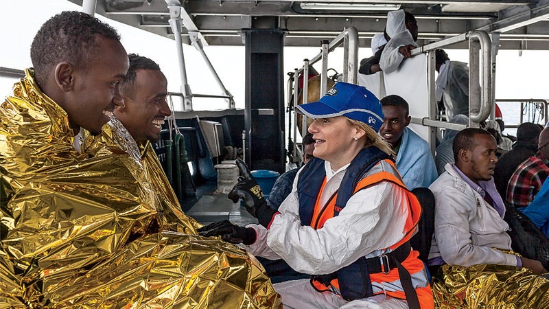Regina Catrambone assists migrants.