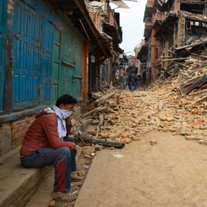 A Nepalese man sits near the debris after the earthquake in Bhaktapur near Kathmandu, Nepal on April 26.