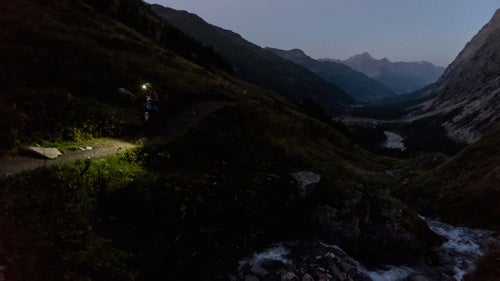 Climbing from Arnuva, a runner races the sun to the top of Gran col Ferret.
