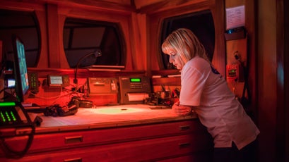 Regina Catambrone looks at the navigation chart on June 10, 2015 during their mission in the Mediterranean Sea.