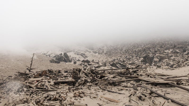 The remains of a wood and stone house in small village of Singdum, just hours after the earthquake unleashed multiple avalanches upon the Langtang valley region. Saturday, April 25, 2015.
