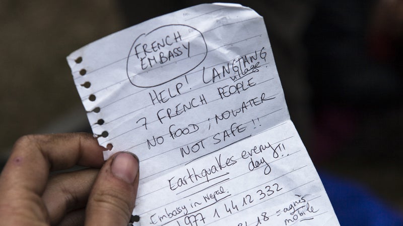 A handwritten note calling for help and carried by those airlifted out.