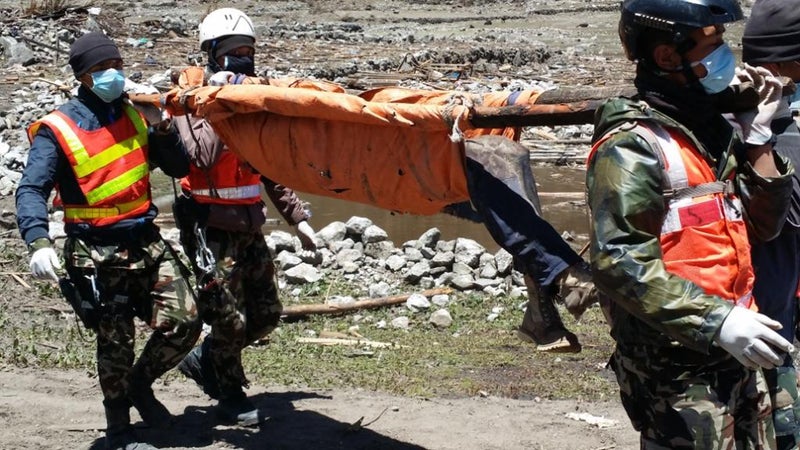 Four Nepalese Army members use a makeshift stretcher during the rescue.
