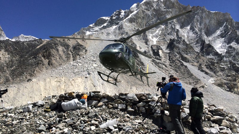 Harvey (right) films a Nepali military helicopter landing for a Beck Weathers rescue sequence at basecamp.