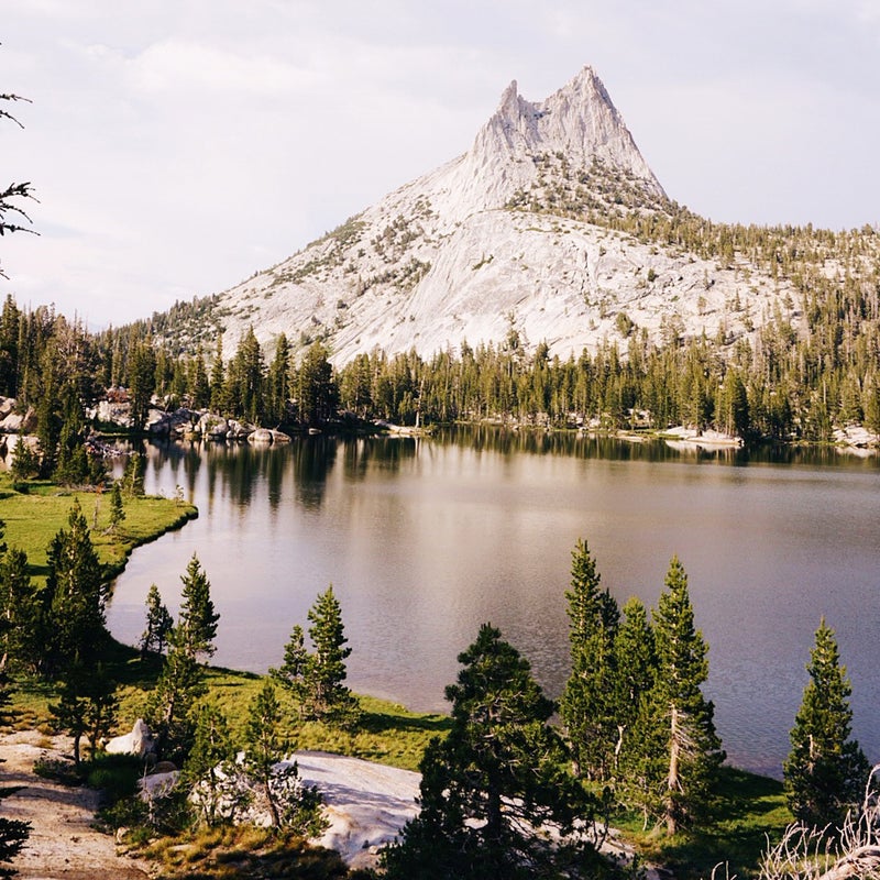 The image of Cathedral Peak was my most popular photo from the trip. It has got to be one of my favorite campsites of the entire trip, although it also ended up being the scariest. Most people camp at the base of the peak on the opposite side of lake; I trekked around to this side so that I could see the peak and hopefully catch its reflection in the water as the sunset.
It had rained on and off all day, but I had gorgeous light in the afternoon and evening as I made camp and cooked dinner. Right after dinner, the sky opened up again: I had strong rains, high wind, and tons of lightning.