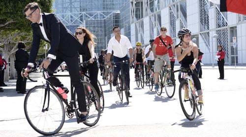 Tom Smuts's Bike Brigade, including actor Jon Huertas (center) arrives at the 67th Primetime Emmy Awards on September 20, 2015.