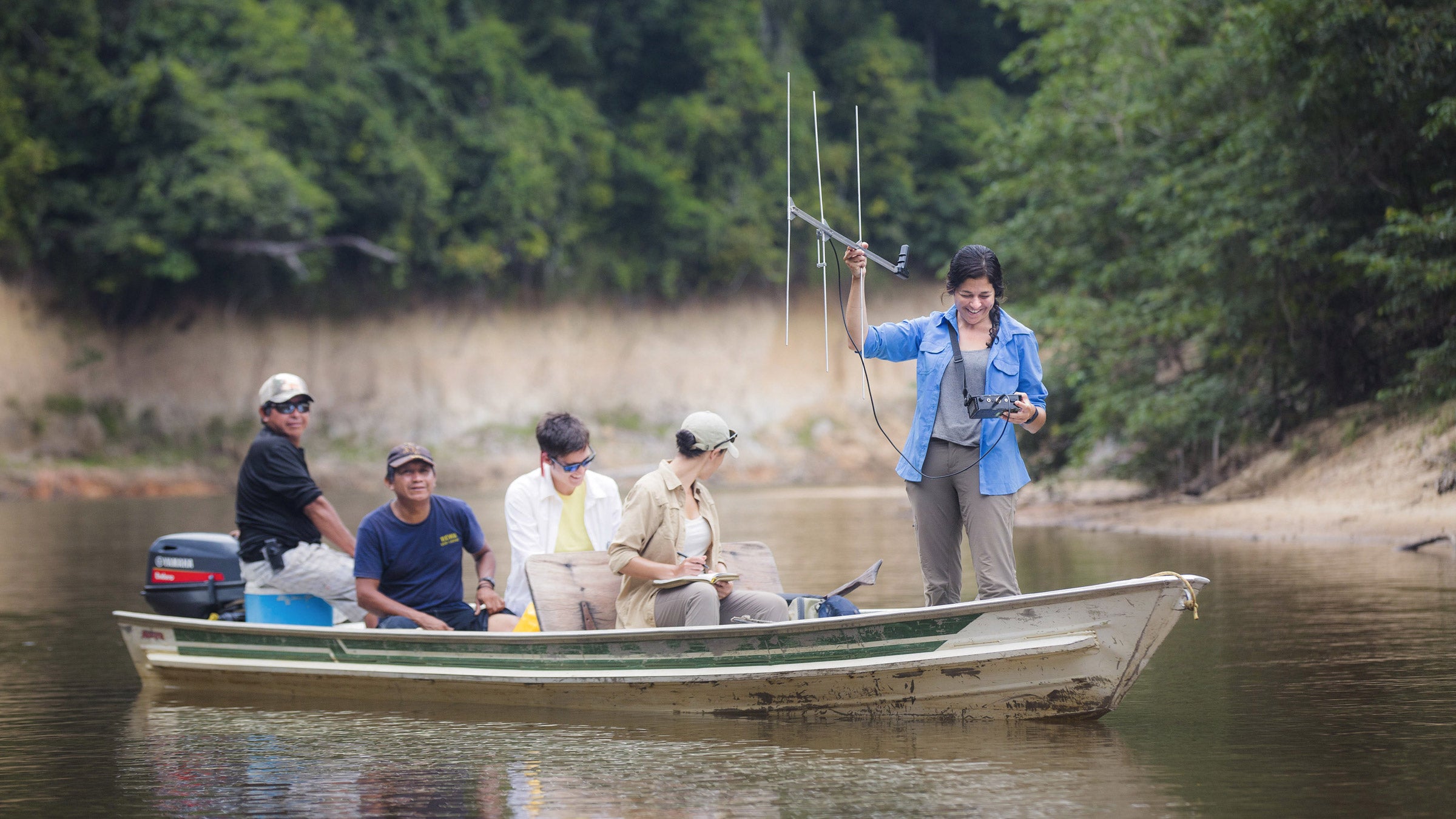Lesley de Souza, right, on an expedition to track arapaima with radio transmitters on the Rewa River, with (from left) Rewa villagers Winston and Rudy Edwards and field assistants Jaclyn Johnston and Piper Kimpel.