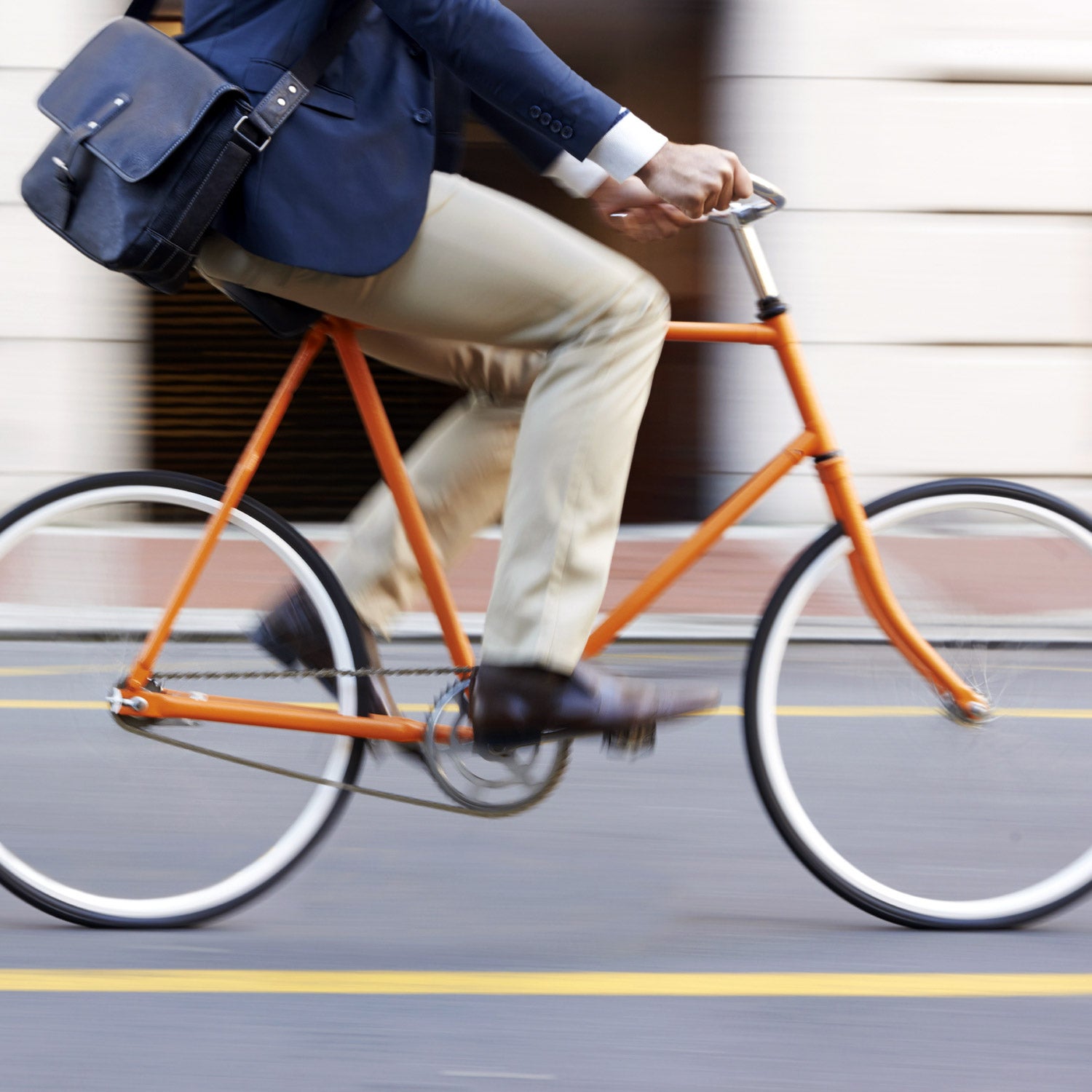 Cropped shot of a man riding his bicycle through the city