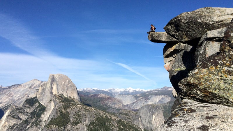 Dean Potter sitting with Whisper at Glacier Point in Yosemite.