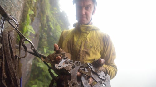 Libecki showing off the gear that keeps them safe—muddy “bird beaks,” which he hammers into small cracks and crevices on lead.