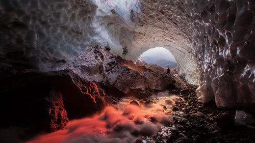 The June expedition was Josh Hydeman’s sixth visit to the Sandy Glacier caves, but the 34-year-old cave photographer said the experience–and the state of the caves–is always different. “Every time I visit the caves there are different things that interest me–a frozen column or a new skylight,” he said. On this trip, he managed to capture where the glow of sunset entering the cave, making the stream appear red. “I’ve never seen anything like that.”