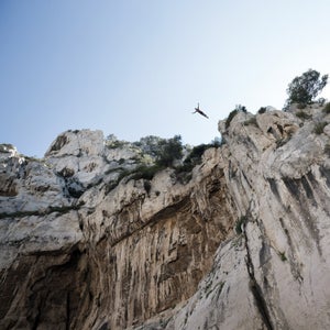 On the rocky shores of Cassis in southern France, the whole village has gathered and the excitement rises as Lionel Franc prepares to dive from 98 feet—his highest ever. After a few minutes of deep concentration, Franc steps forward, raises his arms and jumps into the void. Three seconds later, he enters the water at a speed of 60mph. His trainer and two lifeguards move in to make sure he is safe. He quickly emerges making the OK signal with his hands. 
					
At 45, Franc is one of the few cliff-divers in the world to enter the water head-first. Known around town as Loulou, Franc began diving as a boy and was trained by Jean-Michel Beaujon, who was a student of Father Simon, a famous cliff diver with the nickname “the flying-priest.”  Franc is a father of three and follows an intense physical training plan, dives year round, and, by all accounts, has dedicated life to performing dives from such heights. 
Over the last year, French photographer Brice Portolano spent time with Franc in the calanques—steep-walled inlets of limestone in southern France—and returned with a collection of incredible images. Here, Portolano shares a few of his favorites and a window into the cliff diver’s world.