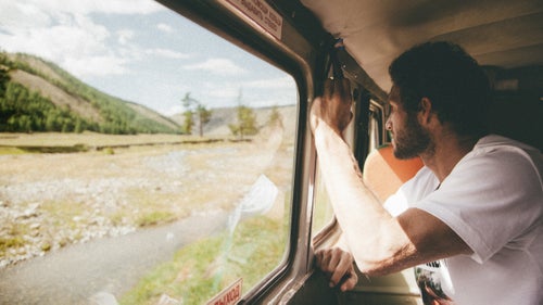 After barely 20 miles of paved road, our stoic driver, Olga, took a random turn off the asphalt and down jarring dirt tracks toward the horizon. The scenery alternated from dense coniferous forests to vast valleys to key-lime hills to dried-up riverbeds. That handle I’m hanging onto in the van ripped off within four hours.