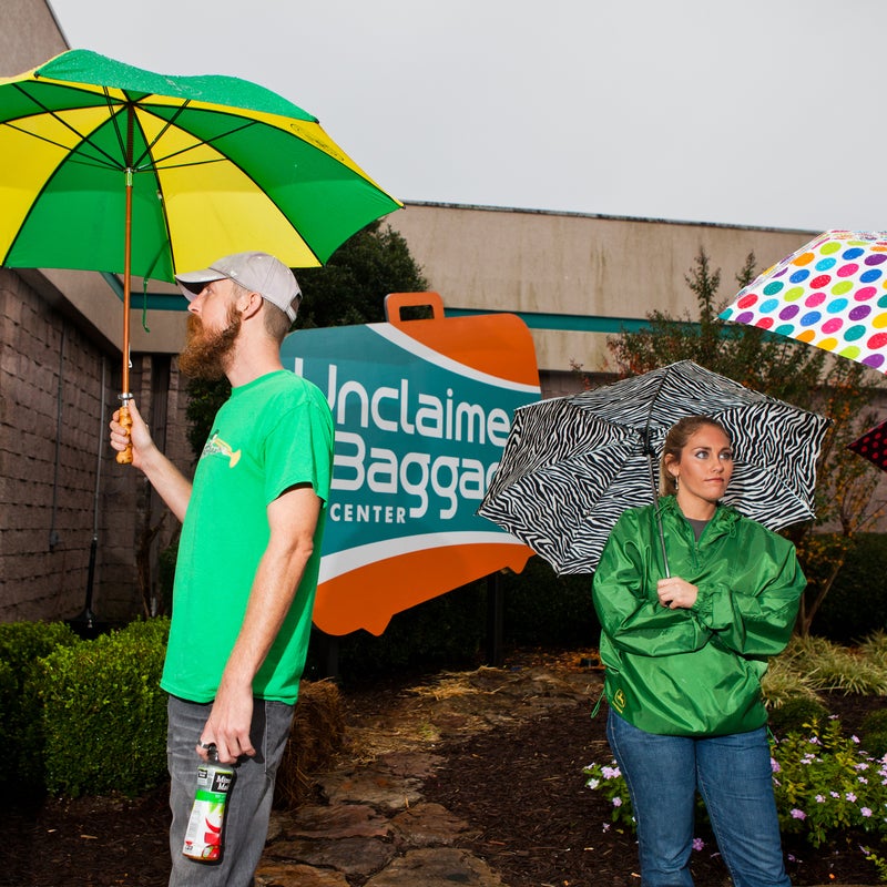 Sam Cordle of Summerville, Georgia, waits in the rain outside the Unclaimed Baggage Center.