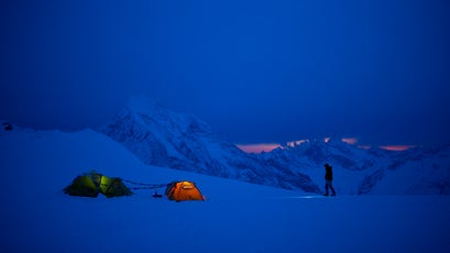 A cold night at 18,000-foot camp​: ​Conrad Anker ​savoring the last bit of twilight, with 20,000-foot Gangchenpo ​Peak looming in the background.