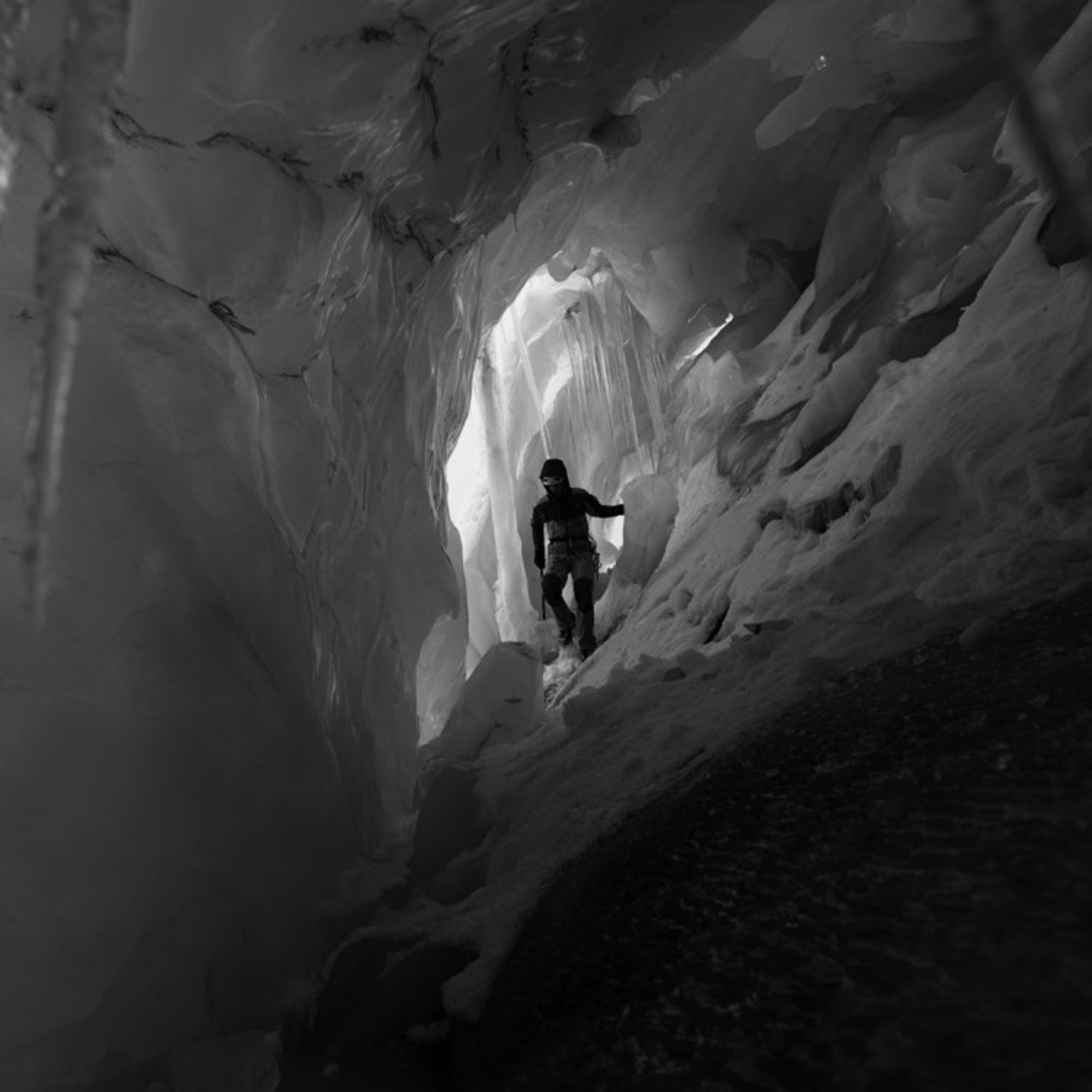 ​The North Face athlete and German alpine climber ​David Göttler exploring an ice cave in the icefall above​ the village of​ Kyanjin Gompa​, in the Langtang Valley.
