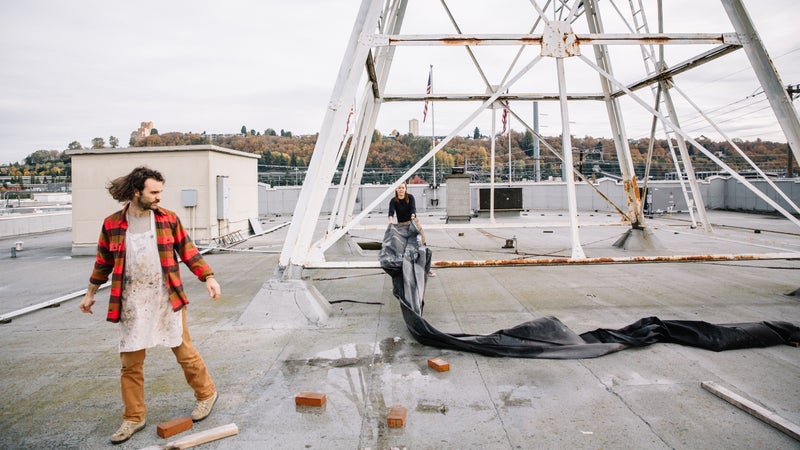Rolling out fabric on the roof.