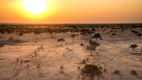 Once a year, Johannesburg-based Wilderness Safaris organizes its Tour de Tuli, a 300-kilometer (186-mile), four-day MTB ride through the Tuli Block of southern Africa, connecting Botswana, Zimbabwe, and South Africa. Unlike other multistage tours through Africa鈥攐r elsewhere around the world鈥攖his one is supported by three separate governments, with makeshift border crossings along riverbanks (you鈥檒l need to keep your Ziploc-ed passport tucked inside your jersey, alongside your energy chews). Capped at 350 riders, plus 150 support staff, the tour fills up fast once it opens for registration each year in late November. Last August, I joined a team led by Russel Friedman, one of Wilderness Safaris鈥 founding partners and chairman of Children in the Wilderness, the educational program Wilderness operates in the communities outside its camps in seven southern African countries. The ride is its chief fundraiser. The course was mostly ancient elephant trails, singletracks across sprawls of loose stones, Moab-style steep cliffs and ridges; forests of swollen baobabs, fever trees, and thorny bush; plus lots of hills and sand, and hills of sand, through a pristine 3,000-square-mile tract that鈥檚 otherwise inaccessible to the public. Friedman broke his back mountain biking last year, yet at 65 he still rode me into the dust鈥攐f which there was plenty. It was the hardest multistage ride I鈥檝e ever been on, but when you鈥檙e with some 300-plus South Africans (plus cyclists from another dozen countries), one thing鈥檚 for sure: At the end of the day, you don鈥檛 drink alone.
Photo: There are lots of ways to go on safari in Africa. By mountain bike is one of them. Fortunately, the riders, not the predators, were the only ones in 鈥渁ttack position.鈥