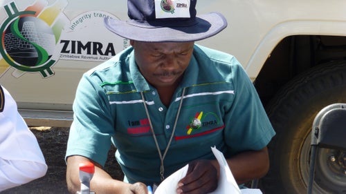 On Day 2, we crossed the Shashe River into Zimbabwe, where immigration officials sorted through our passports, dutifully writing down the serial numbers of each bill we used to pay for our entry visas. The customs officer was particularly friendly and happy to pose for photos. The logo on his shirt reads, 鈥淚 am not corrupt.鈥