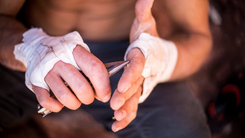 Hamilton Holland came to the Creek from Flagstaff for perfect cracks and the chance to meet up with friends from Montana. While scouting a route, he tripped on a cactus. Here he sits in the shade picking spikes from his hand.