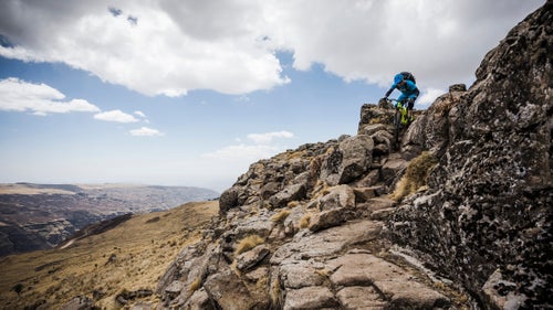 In late February, I went with a small team of mountain bikers, including MTB World Cup champ Kamil Tatarkovic and pro mountain bike racer Sarah Leishman, on an expedition to the Simien Mountains of northern Ethiopia. The stated goal was to summit the country’s highest peak, 14,928-foot Ras Deshan, and ride back down.
The expedition was a terrible idea, mostly because the trails were sometimes about as rideable as cocaine-addled donkeys. There were 1,500-vertical-foot hike-a-bikes—both up and down. Every single one of us went over the bars. The crew caught dozens of scrapes, a softball-size contusion, a festering eye infection, and stitches in the chin. And day after day, we were half-wheeled and passed by muleteers and local marathon runners.
And yet our Giro-sponsored group made the trip’s high point and found some incredible singletrack along the 10-day route. We saw some of the world’s wildest and most untamed mountains, shared trailside injera with villagers who spoke only Amharic, were chased by exuberant children at almost every turn, learned the Ethiopian national shoulder dance (badly!), and pedaled our bikes in places that few people will ever be lucky enough to experience.