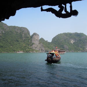 Nguyen climbs slick limestone over the waters of Cat Ba Island in Ha Long Bay.