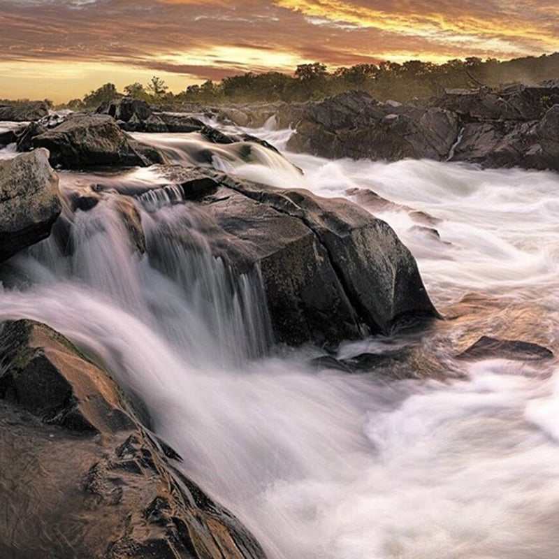 The Potomac River rushes over jagged rocks in the Virginia park.