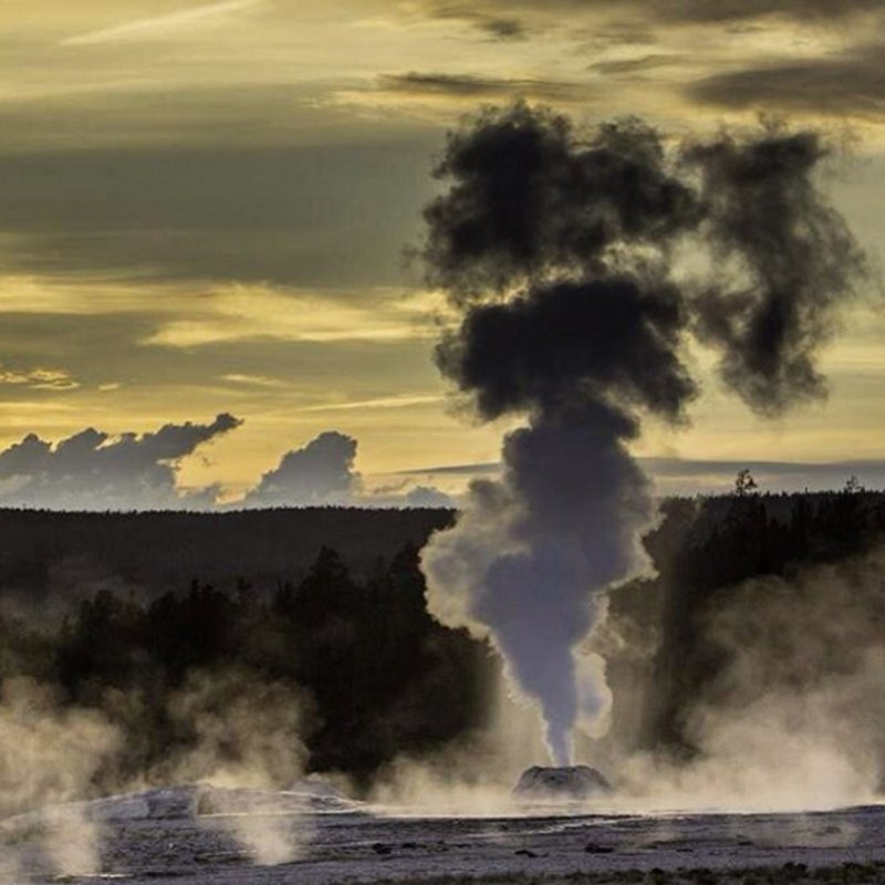 The Lion Geyser, named for the roaring sound it emits during an eruption, sends up white and black steam at sunset.