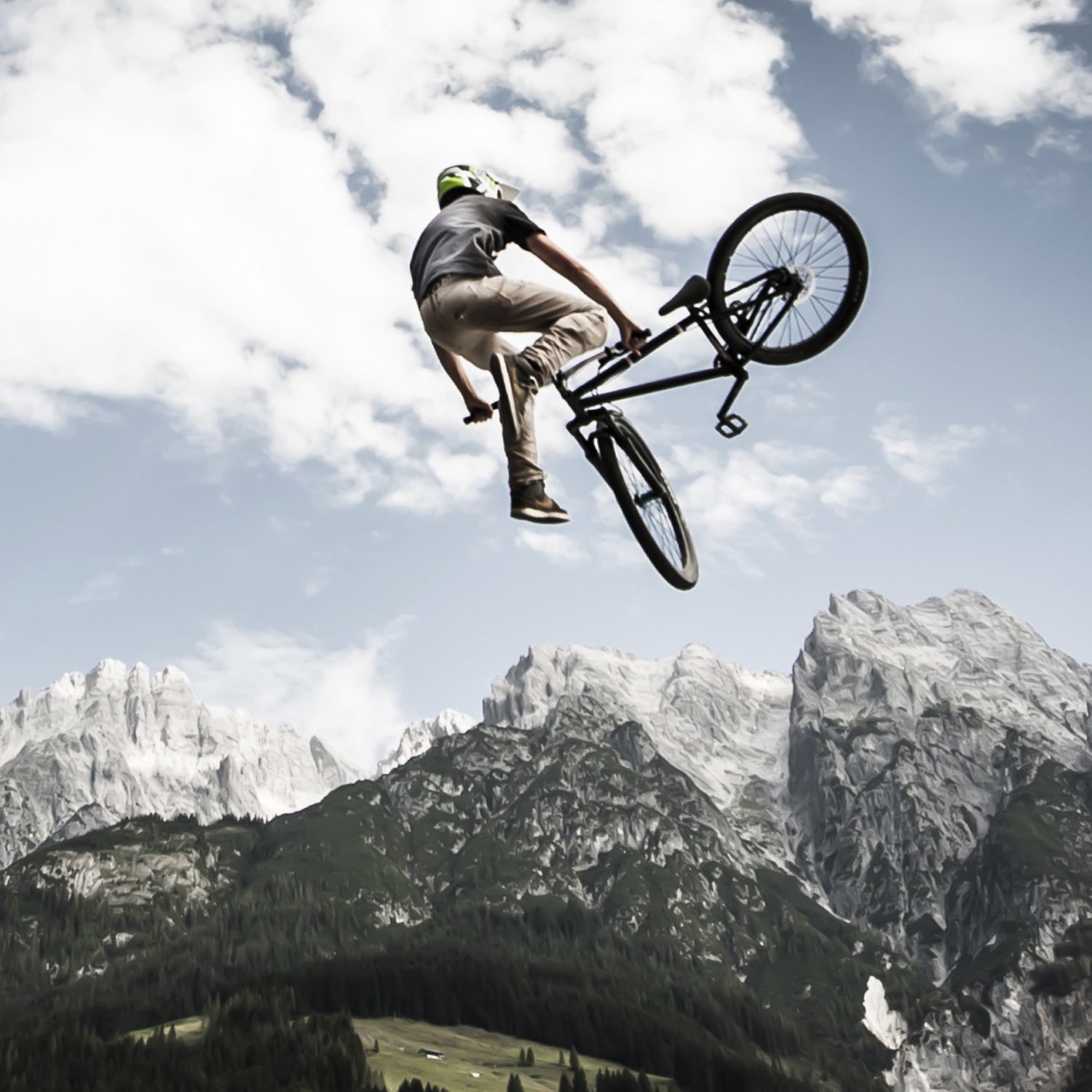 biker rotates his bike arround high in the air