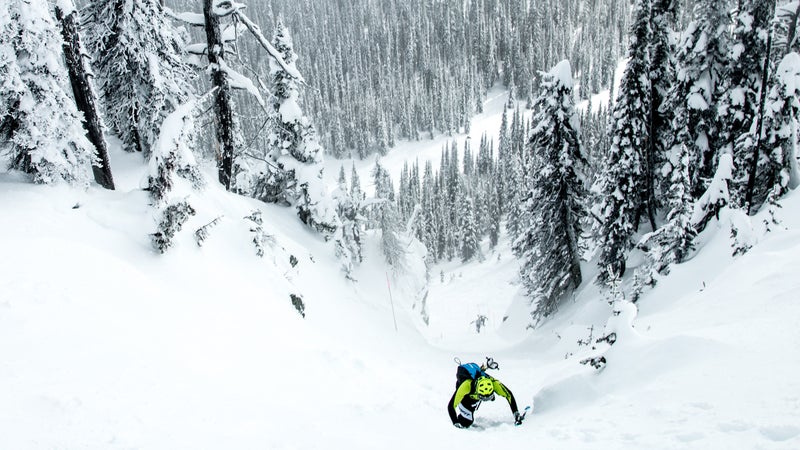 A racer bootpacking up a Montana chute.