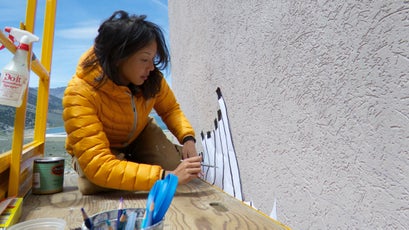 Jane Kim working on her Sierra Nevada Migrating Mural, depicting bighorn sheep.