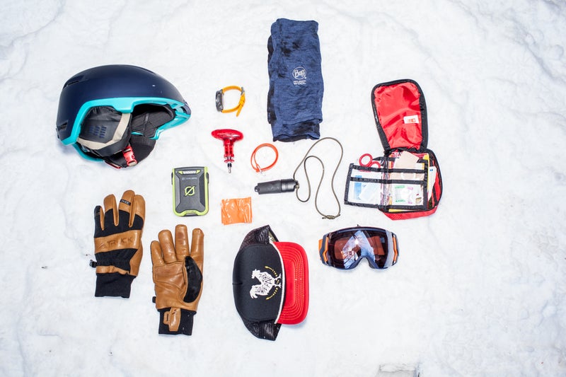 Clockwise from top left: Topo Designs X Giro Edit, Suunto Traverse, Brooks-Range Mountaineering ski binding tool, Voil茅 strap, merino wool Buff, Exotac Firesleeve, REI first-aid kit, Smith X Owner Operator I/O 7 goggle, Howler Bros mesh-back trucker hat, duct tape, Goal Zero Venture 30, Truck M1 gloves.