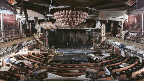 A former theater lies destroyed and rotting.