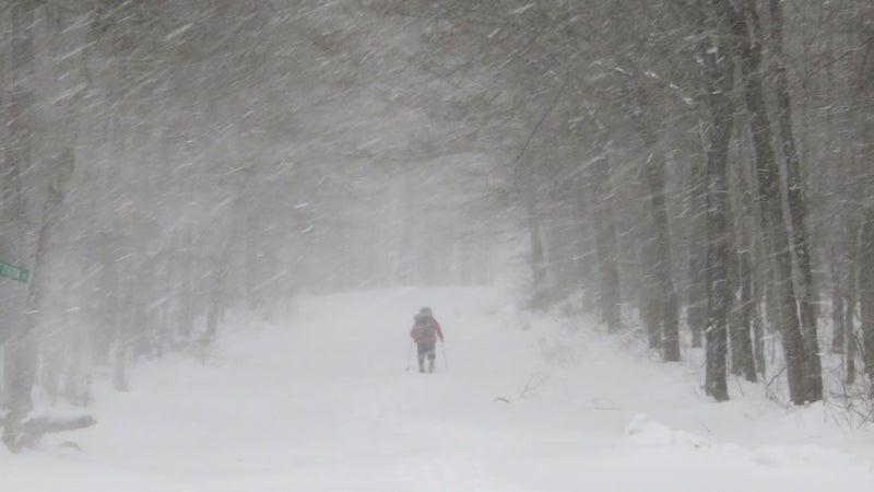 After waiting out a storm near Gorham, NH, Gathman trudges through fresh powder at Crawford Notch to continue south through the White Mountains.