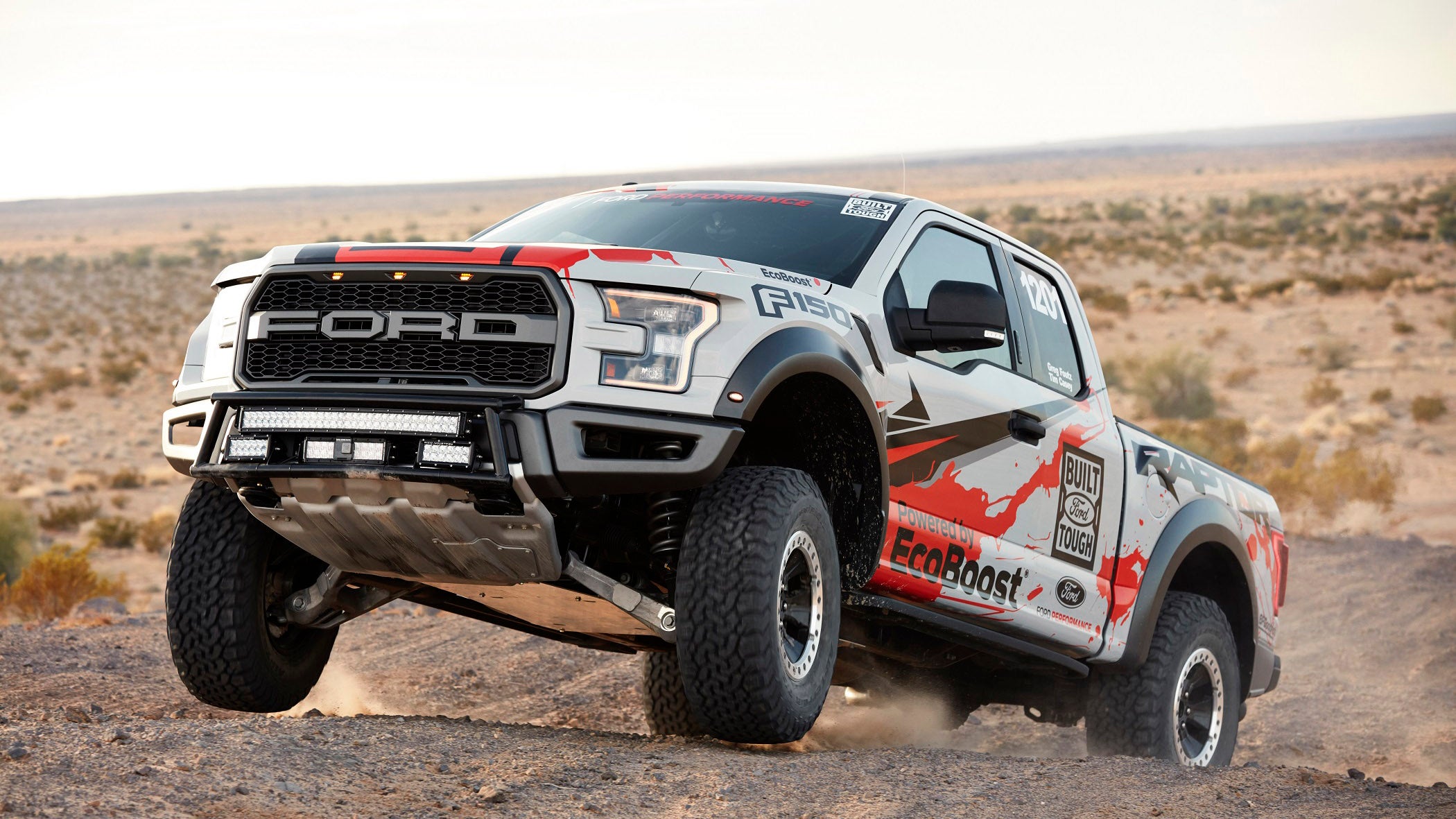 The 2017 Ford F-150 Raptor race truck gets a little air during testing. Due to liability, Ford isn't supposed to show the truck jumping at all. Take it from us: it can.
