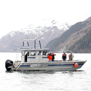 Wide shot of shrimp boat on water.