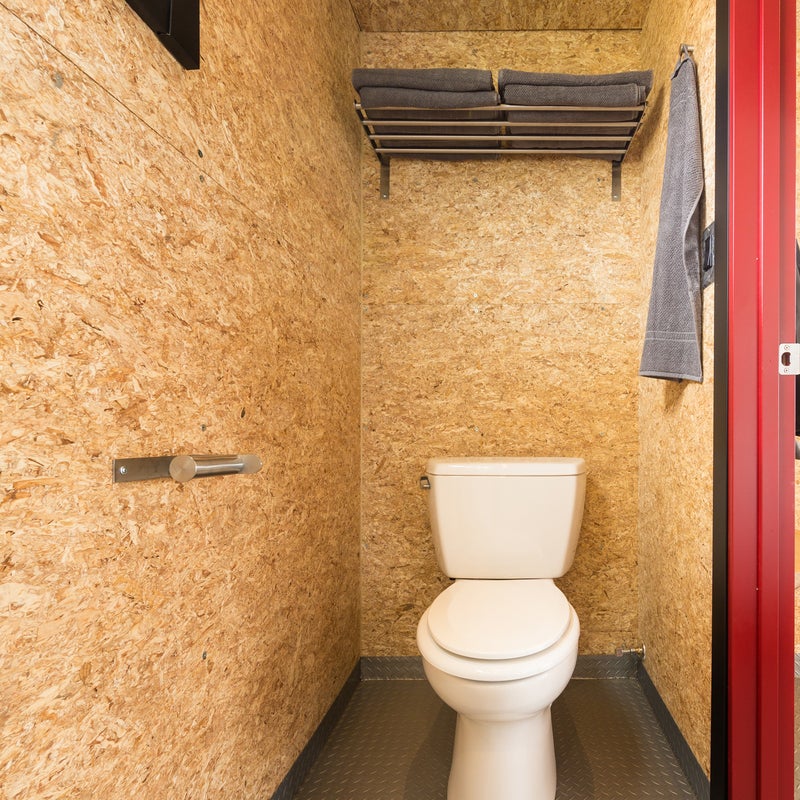 Like the rest of the unit, the toilet area has wood walls and plenty of storage for essentials.