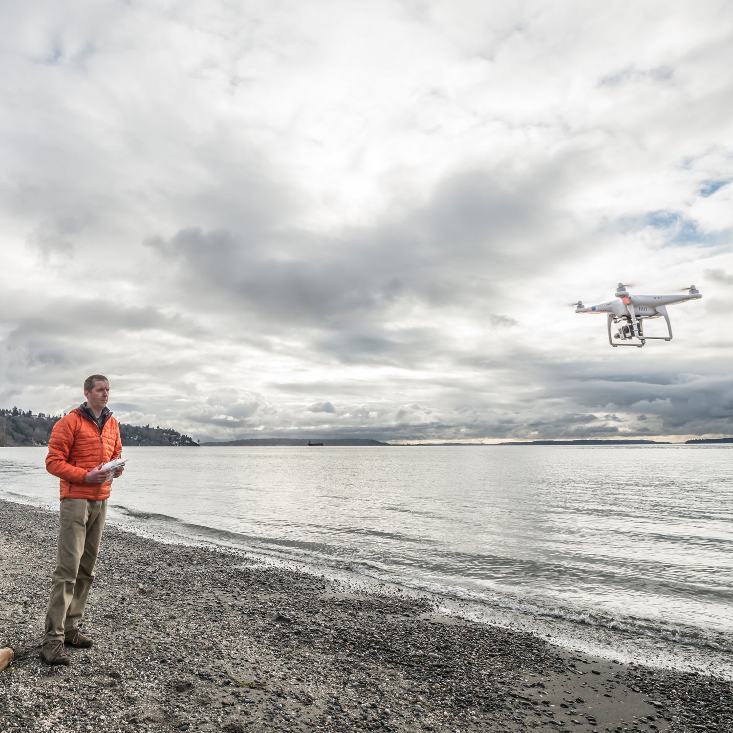 Alasdair Turner operates quadcopter drone at a beach in Seattle