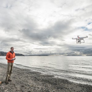 Alasdair Turner operates quadcopter drone at a beach in Seattle