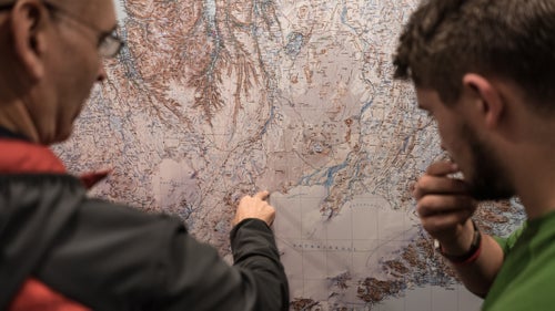 Adventure filmmakers Taylor Rees and Renan Ozturk thought it would be a mellow working vacation: they’d capture footage of four young Brits as they traversed 250 miles of Iceland’s fissured terrain, starting in December. Aspiring explorers Charlie Smith, Stefan Rijnbeek, Angus Dowie, and Archie Wilson (all either 19 years old or 20) planned to weave a line from the island nation’s northernmost nexus with the Norwegian Sea to its southernmost boundary with the North Atlantic. They branded the expedition as the first continuous, unsupported winter crossing of the island nation (a claim that was later refuted by a veteran of the Icelandic Alpine Club).

They hoped their example would inspire young folks to get outdoors. But the crossing wasn’t as simple as they’d hoped. “The conditions here are far beyond anything we could have expected,” Ozturk wrote on Facebook during the expedition. “And when storms like these blow sleeting wet snow and soak even our outer Gortex [sic] layers, survival becomes so critical that the quality of shooting seems futile.”

Then a storm of biting media reports—focusing mainly on the young men needing rescue on three separate occasions—brought about a public shaming that culminated in death threats against the team. 

Here’s a look at the expedition, and where and when it went wrong.

Photo: December 2: Icelandic Association for Search and Rescue (ICE­-SAR) project manager Brandur Örn Arnarson (left) discusses the team’s route with expedition leader Charlie Smith. Brandur spelled out the route’s hazards and suggested a safer path to avoid rivers and glaciers. “Brandur told us that he wouldn’t personally cross Iceland in winter, but that he understood why we’d want to do it,” Smith said.