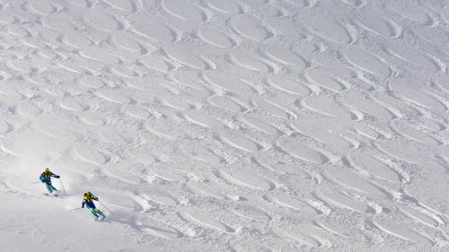 After a decade-long hiatus, Jackson Hole鈥檚 famous Powder 8鈥檚 competition returned last weekend. Pairs of skiers competed to create the most symmetrical figure eights while tearing down Cody Bowl just outside the ski area boundary. With one skier following the other, five judges also critiqued their timing and skiing style.
The event, which started in 1975, fell off back in the early 2000s as freeride and big mountain competitions gained popularity and synchronized skiing became pass茅. The resort decided to reinstate it as part of its 50th anniversary celebration, and, like many retro trends in skiing these days (think onesies, Pit Vipers) it was warmly welcomed back. Teams flew in from across the country to compete, GoPro ponied up $10,000 in prize money, and many hope there are plans to continue the competition next year.
Photo: Teresa Gurdin and Victor Gurdin ski their line during the competition.
