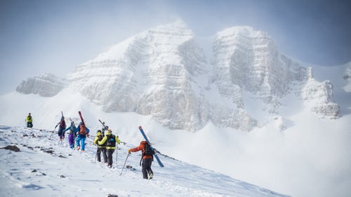 Cody Peak looms over competitors as they hike to the start.
