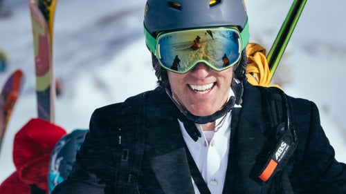 Jeff Annetts hikes toward the top of the Powder 8's venue in his tuxedo.