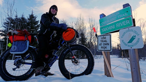 Jeff Oatley meets Brent Sass near the end of the Yukon Quest trail in Whitehorse on Monday.